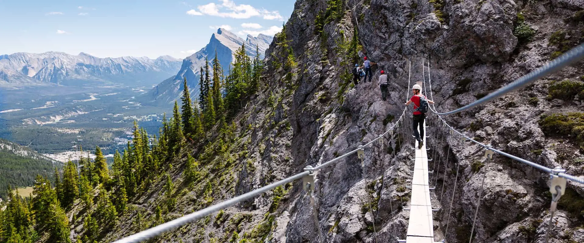 Cross a suspension bridge on the Mount Norquay Via Ferrata Explorer Route